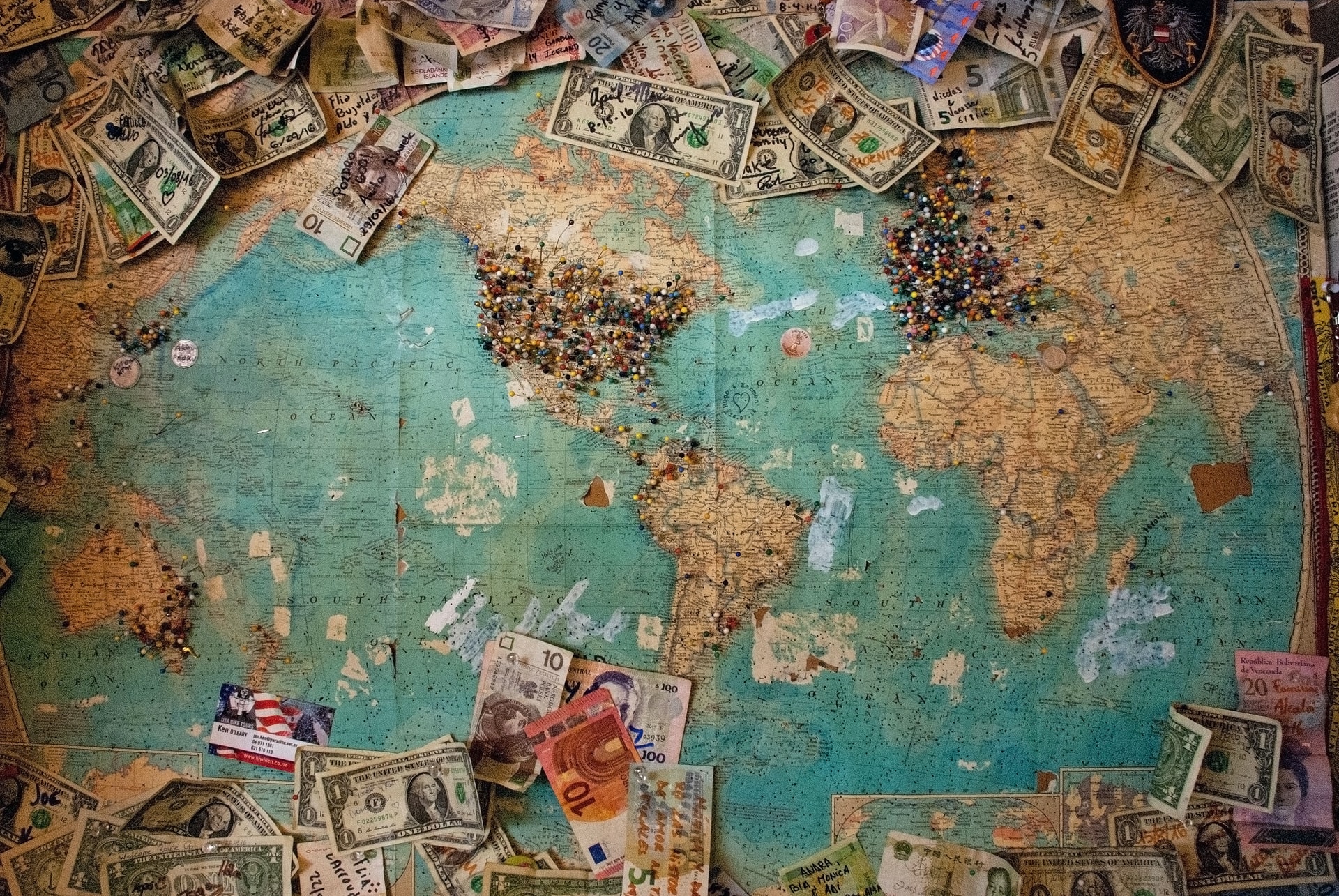 world map with currency on it